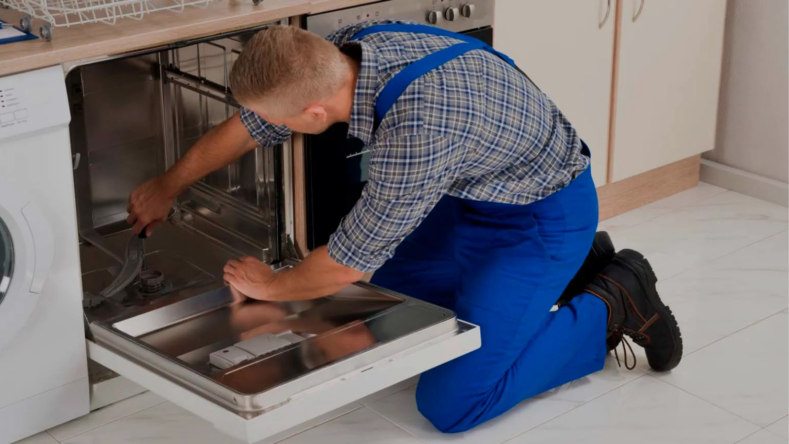 technician repairing a dishwasher