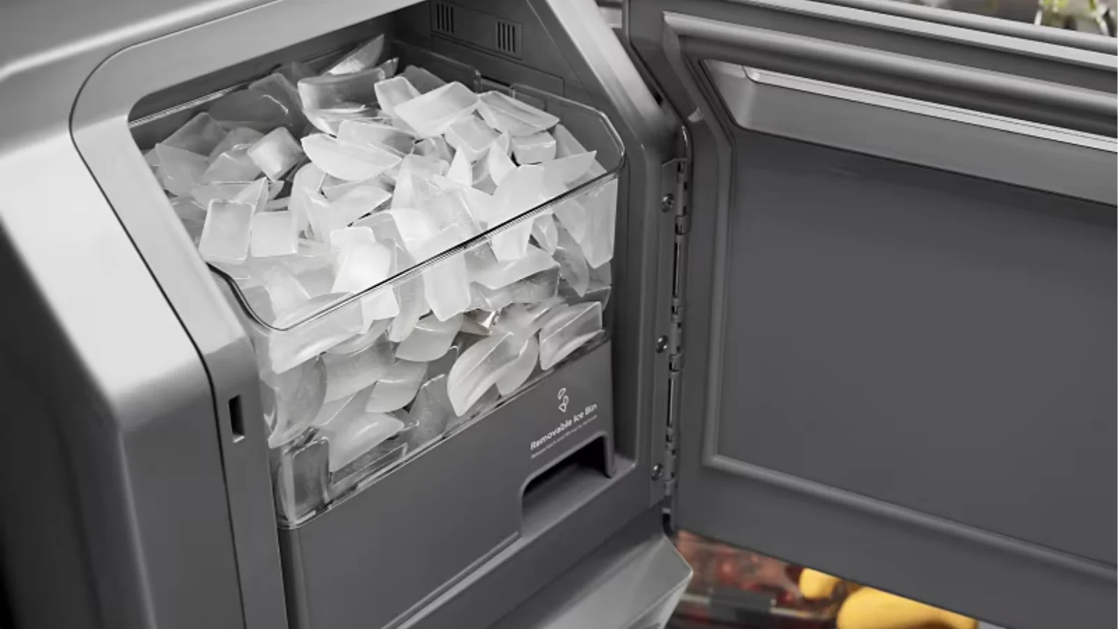 Overfilled Samsung refrigerator ice bin showing ice buildup that may require removing the ice maker.