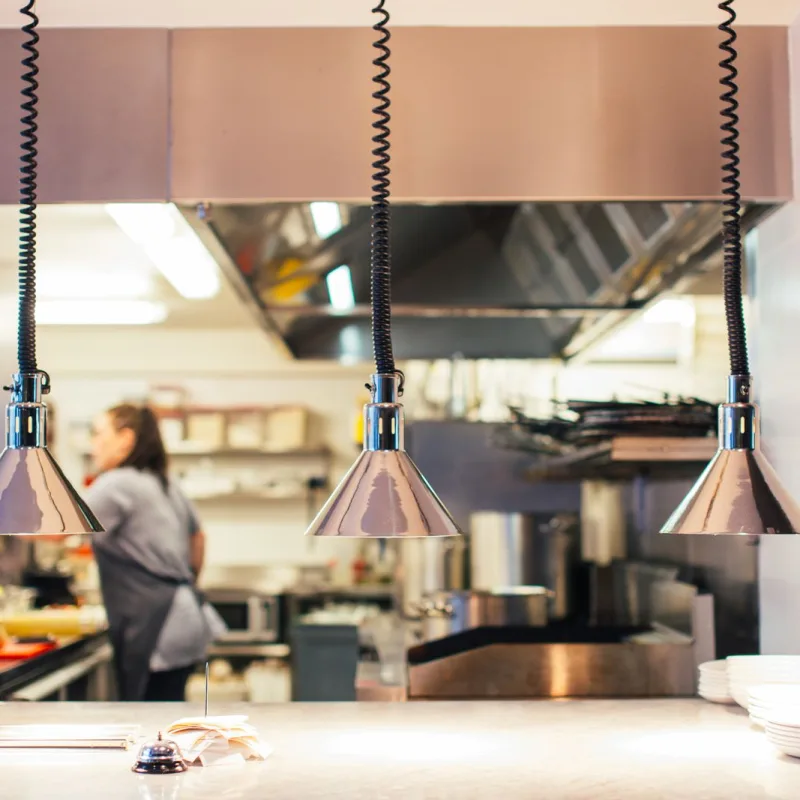 Working commercial restaurant kitchen line with heat lamps